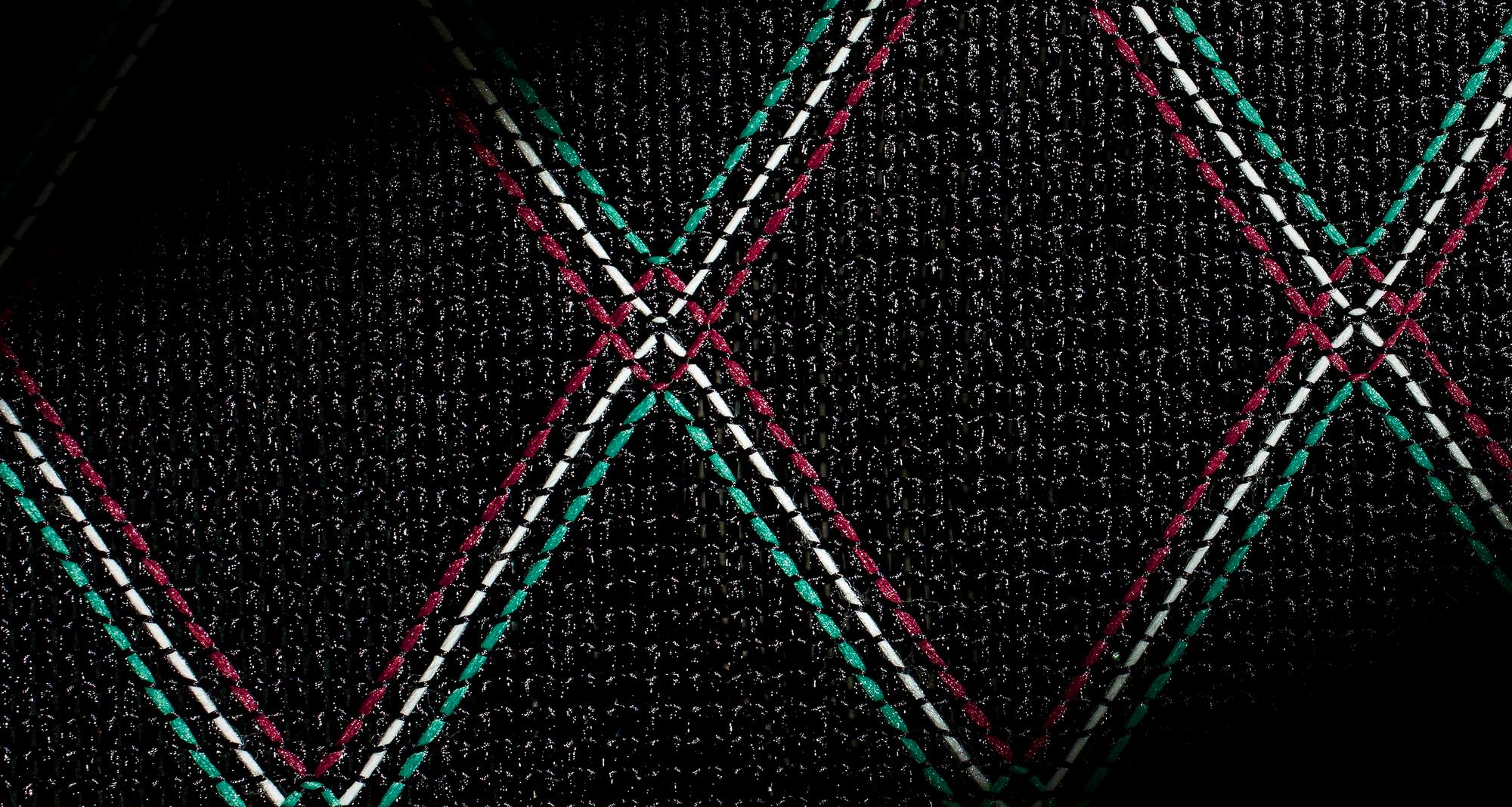 Modern geometric stitch on dark fabric