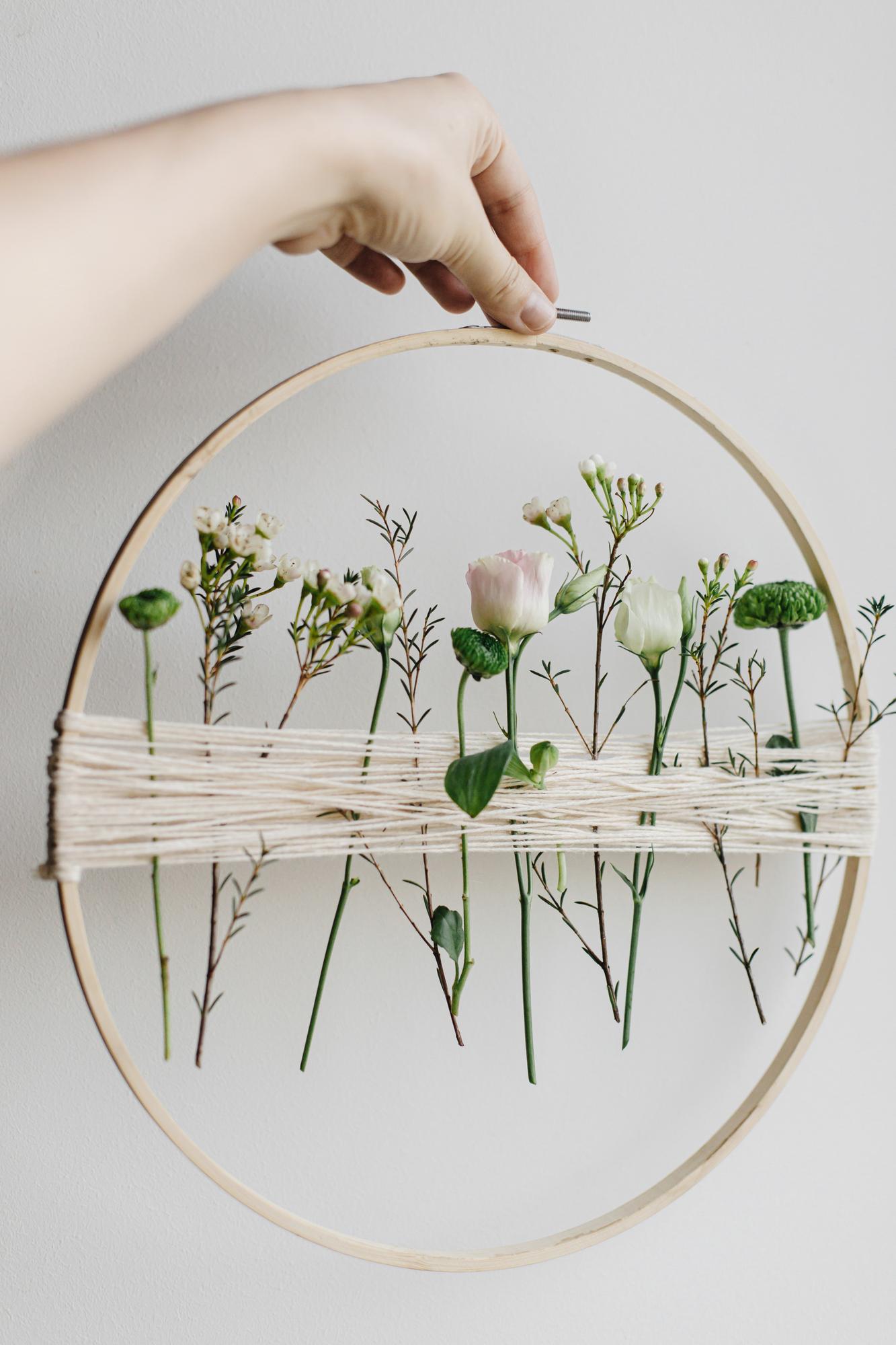 Workshop hands finishing an embroidery hoop